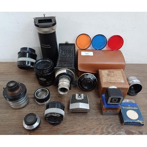 671 - A collection of lenses and photography accessories to include Asahi Opt. Co. Macro-Takumar 1:4/50 le... 