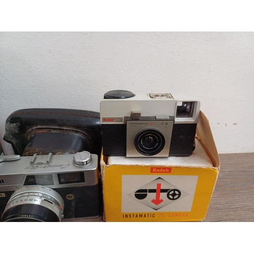 677 - A collection of cameras and binoculars to include cased Canon Canonet QL19 35mm rangefinder camera, ... 