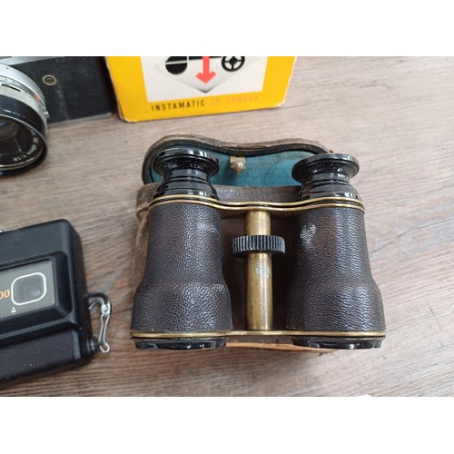 677 - A collection of cameras and binoculars to include cased Canon Canonet QL19 35mm rangefinder camera, ... 