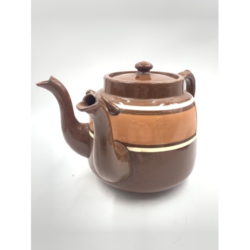 316 - A brown glazed terracotta double spouted teapot - approx. 20cm high