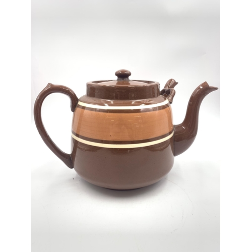 316 - A brown glazed terracotta double spouted teapot - approx. 20cm high