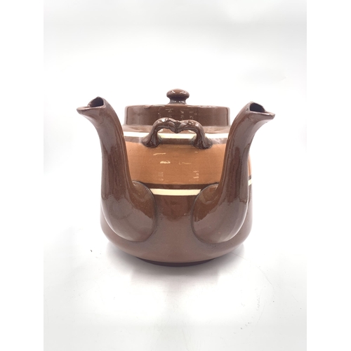 316 - A brown glazed terracotta double spouted teapot - approx. 20cm high