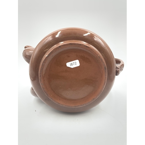 316 - A brown glazed terracotta double spouted teapot - approx. 20cm high