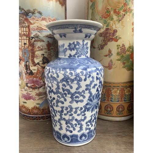 360 - Five oriental ceramic items, three stick stands and two vases - largest approx. 62cm high