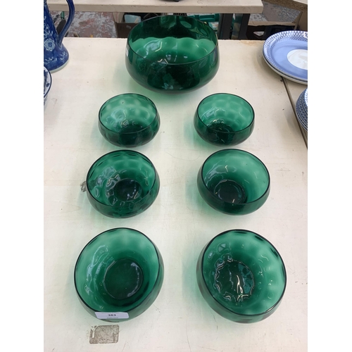 383 - Seven green glass bowls - largest approx. 20cm diameter