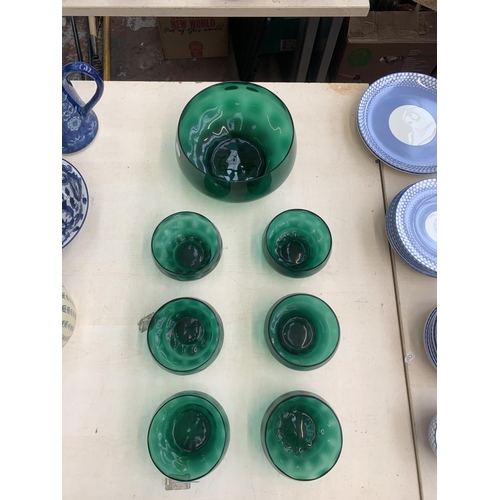 383 - Seven green glass bowls - largest approx. 20cm diameter