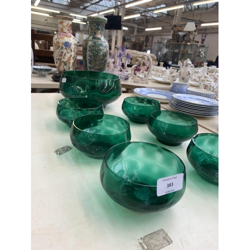 383 - Seven green glass bowls - largest approx. 20cm diameter