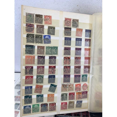 484 - Five stamp albums containing a collection of worldwide stamps