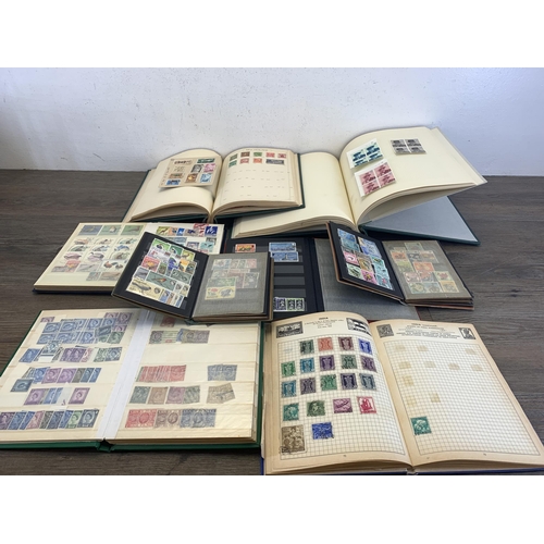 496 - Six albums and two stock books containing a collection of worldwide stamps