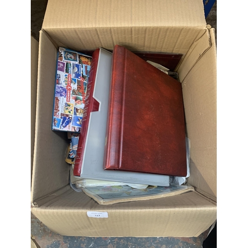 517 - A box containing a large quantity of loose stamps and first day covers