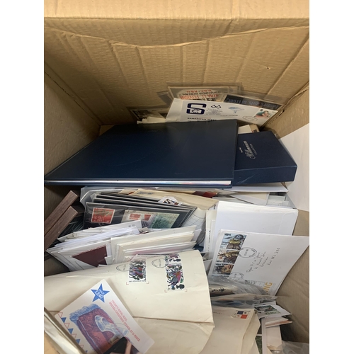 518 - A box containing a large quantity of loose stamps and first day covers