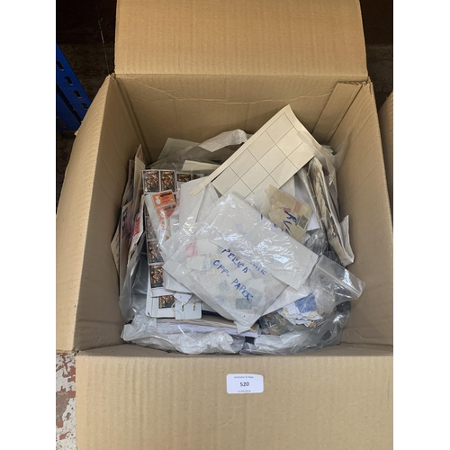 520 - A box containing a large quantity of loose stamps and first day covers