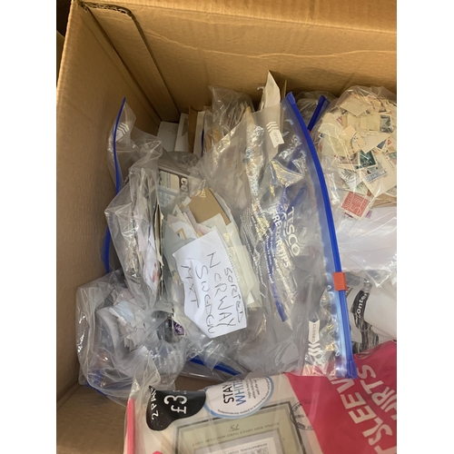 522 - A box containing a large quantity of loose stamps and first day covers