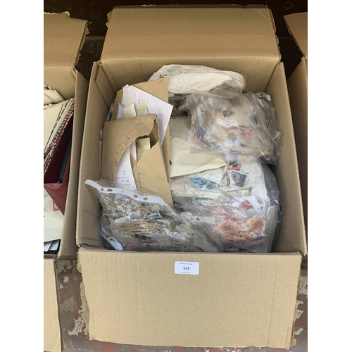 523 - A box containing a large quantity of loose stamps and first day covers