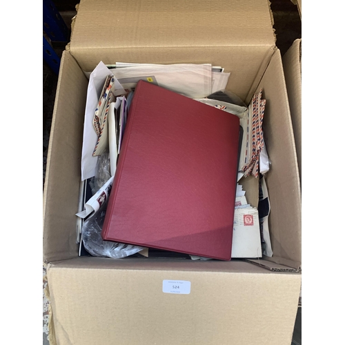 524 - A box containing a large quantity of loose stamps and first day covers