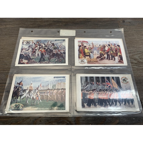 549 - A collection of antique and later postcards to include World War I silk titled Hands Across the Sea,... 