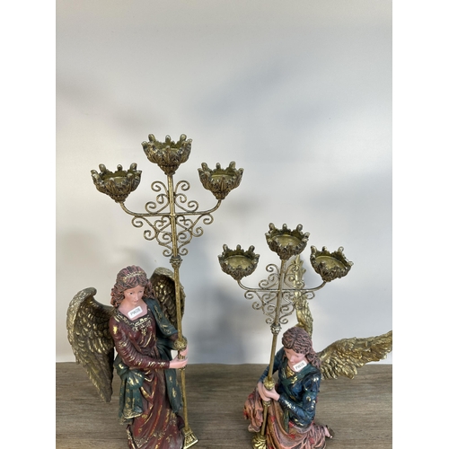 556 - A pair of contemporary angel three branch candelabras - largest approx. 68cm high