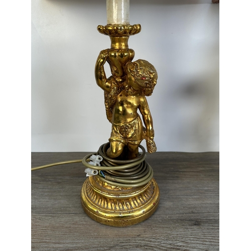 558 - A pair of 19th century style gold painted Putti table lamps with pink shades - approx. 63cm high