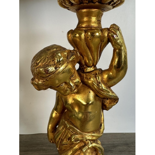 558 - A pair of 19th century style gold painted Putti table lamps with pink shades - approx. 63cm high