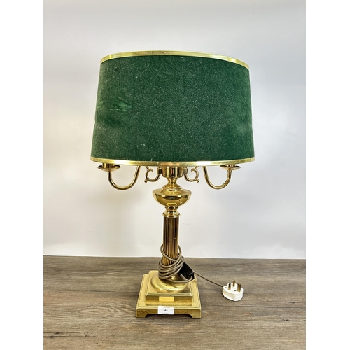 561 - A vintage brass effect two branch table lamp with green felt shade - approx. 59cm high