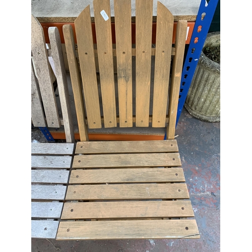 886 - Three teak folding garden chairs