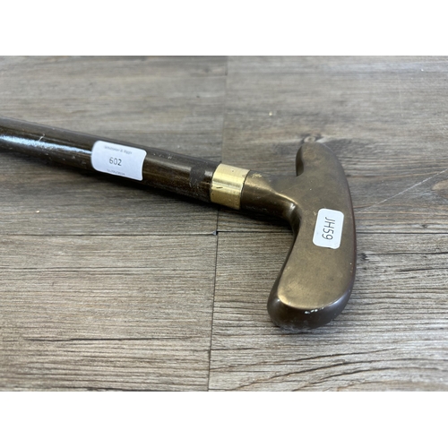 602 - A novelty brass and hardwood golf putter handle walking stick - approx. 87cm long