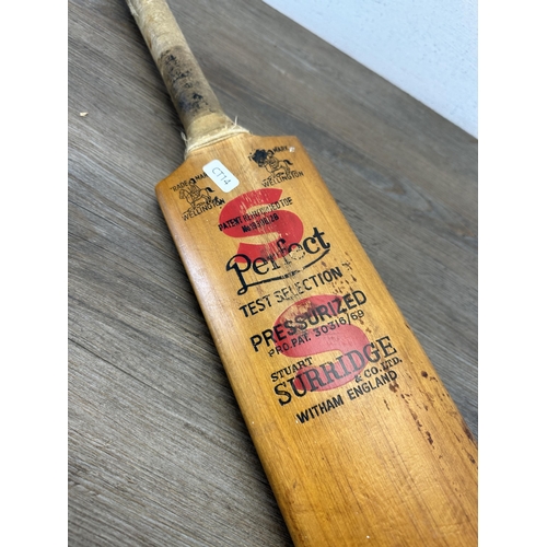 608 - A vintage Stuart Surridge & Co. Ltd. cricket bat - approx. 84cm long