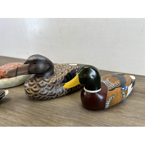 612 - Four hand-painted decoy ducks, three wooden and one terracotta