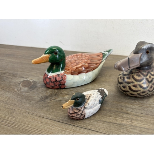 612 - Four hand-painted decoy ducks, three wooden and one terracotta