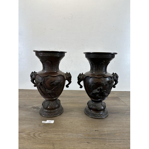 616 - A pair of Japanese Meiji period bronze twin handled vases with bird and foliate design - approx. 34c... 