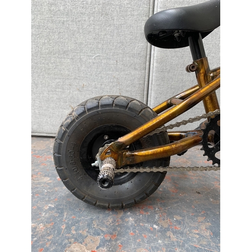 855 - A Venom mini BMX bike with stunt pegs