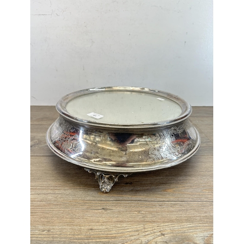 403 - A 19th century silver plate and mirrored glass circular tri-footed cake stand - approx.14cm high x 4... 