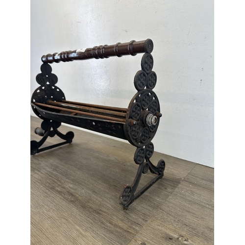 404 - A 19th century style cast metal newspaper log roller - approx. 36cm high x 43cm wide