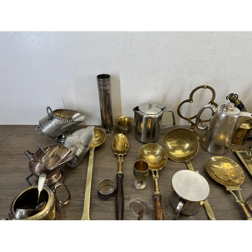 406 - A collection of antique and later metalware to include brass beehive candlestick - approx. 36cm high... 