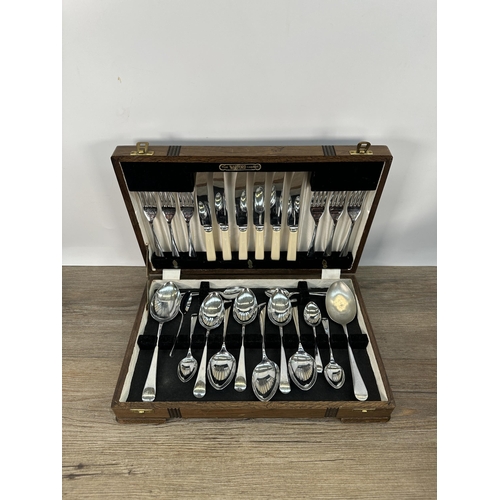 422 - A collection of metalware to include vintage catering equipment, loose cutlery, 1930s oak cased Watf... 