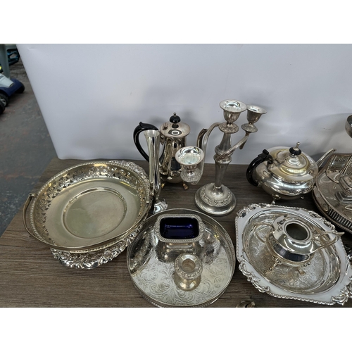 423 - A collection of 19th century and later EPNS and silver plated ware to include candelabras, three pie... 