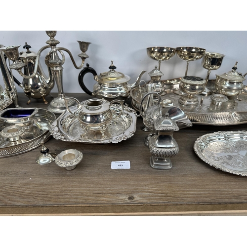 423 - A collection of 19th century and later EPNS and silver plated ware to include candelabras, three pie... 