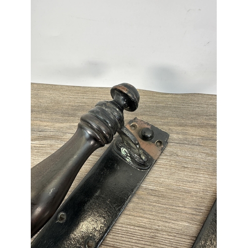 427 - A pair of 19th century cast metal and turned wooden door pulls - approx. 30cm high