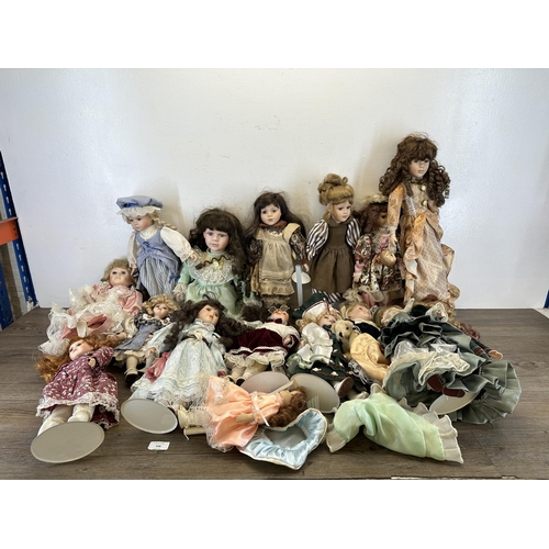 438 - A collection of porcelain headed dolls