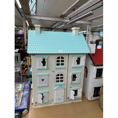 444 - A wooden three storey dolls house - approx. 84cm high x 60cm wide