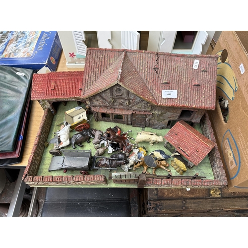 445 - An early to mid 20th century scratch built farmyard with various accessories and lead figurines to i... 