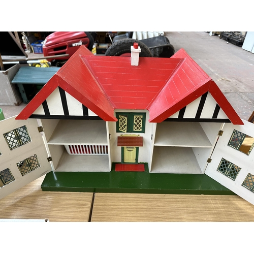 455 - A 1960s scratch built wooden, metal and hand-painted two story doll's house - approx. 42cm high x 72... 