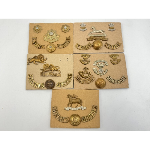 2223 - Five carded sets of military cap badges and shoulder titles