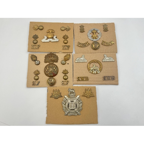 2229 - Five carded sets of military cap badges and shoulder titles