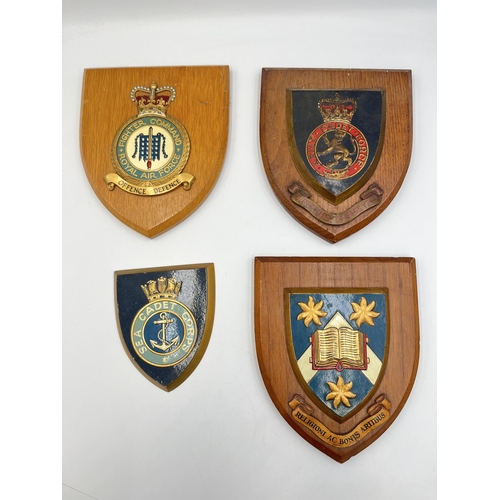 2258 - Four vintage hand painted shield wall plaques to include Royal Air Force Fighter Command, Army Cadet... 