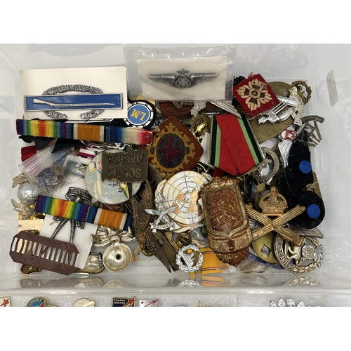 2261 - A collection of military items to include F. W. C. & S. Ltd RAF sweetheart brooch, cap badges etc.