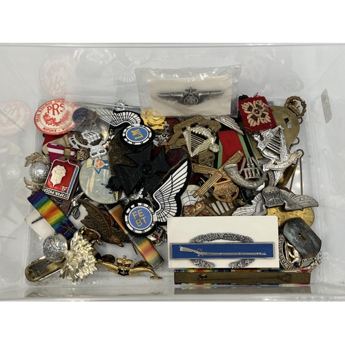 2261 - A collection of military items to include F. W. C. & S. Ltd RAF sweetheart brooch, cap badges etc.