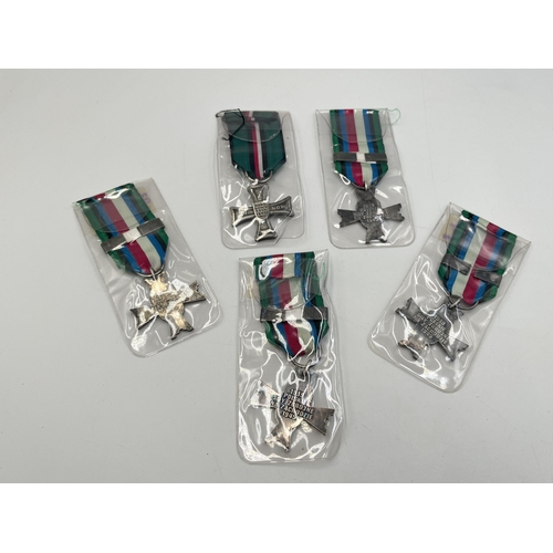 2302 - Five WWII Polish medals, four 1939-1945 Military Cross Of Combat and one National Defence