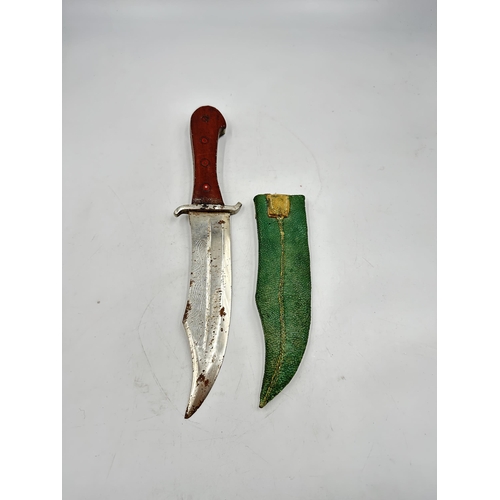 2141 - A vintage Middle Eastern hunting knife with sheath - approx. 32cm long