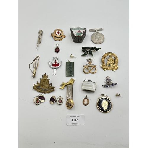 2146 - A collection of items to include four military cap badges, WWII Victory medal, Chinese white metal a... 